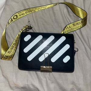 Black and white striped bag with yellow strap